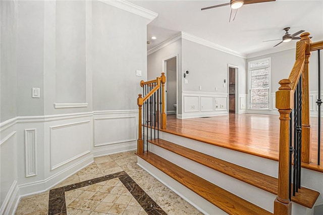5575 Julian Pl, Atlanta, GA 30342 - stairs with ceiling fan, inlaid floor details, crown molding, a decorative wall, and a wainscoted wall