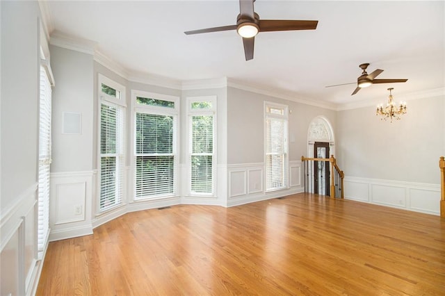 5575 Julian Pl, Atlanta, GA 30342 - unfurnished room with a decorative wall, ceiling fan, a chandelier, wainscoting, and light wood-type flooring