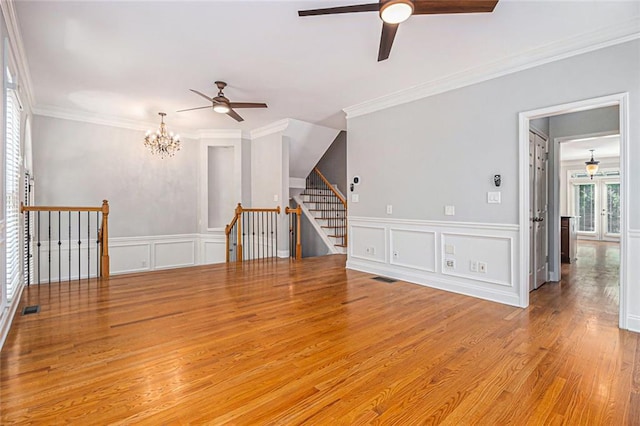 5575 Julian Pl, Atlanta, GA 30342 - unfurnished living room featuring ceiling fan, a decorative wall, wood finished floors, ornamental molding, and a chandelier