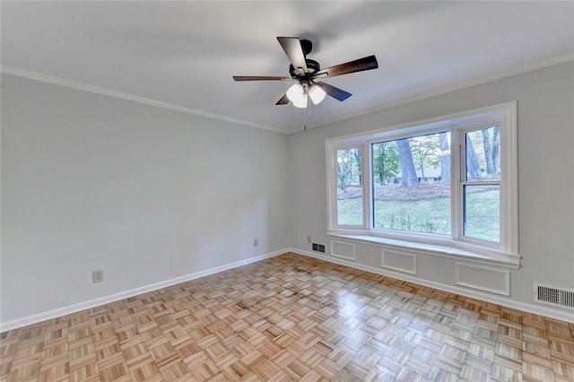 spare room featuring ceiling fan, ornamental molding, visible vents, and baseboards