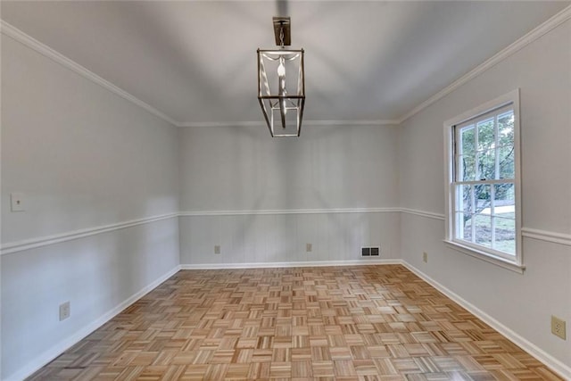 empty room with baseboards, visible vents, a chandelier, and crown molding