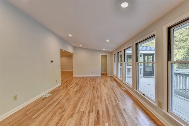 spare room featuring light wood-style floors, recessed lighting, visible vents, and baseboards