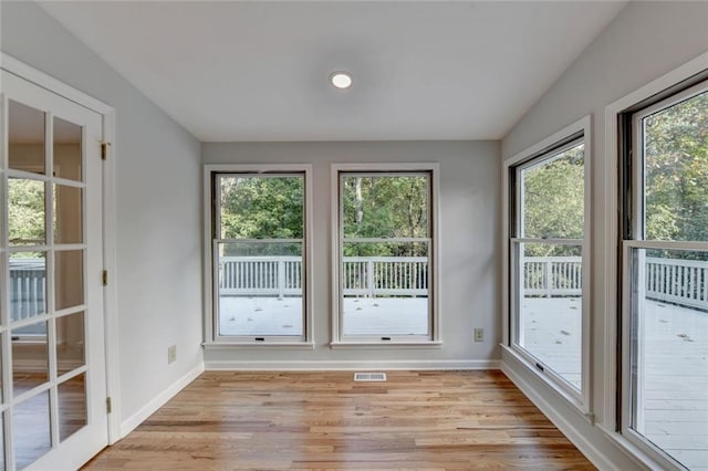 unfurnished sunroom with visible vents