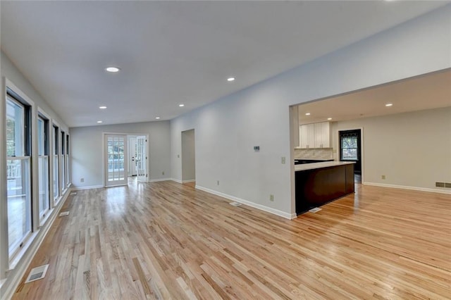 unfurnished living room with light wood-style floors, recessed lighting, visible vents, and baseboards