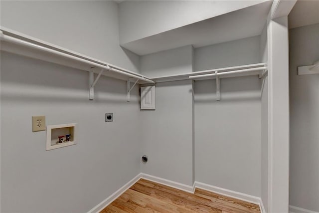 clothes washing area with laundry area, baseboards, light wood-style floors, washer hookup, and electric dryer hookup