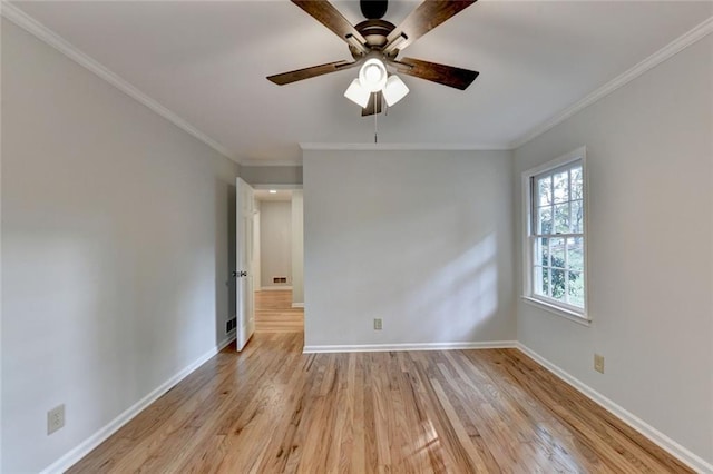 empty room featuring crown molding, ceiling fan, light wood-style flooring, and baseboards