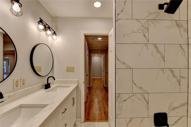 full bath featuring double vanity and a sink