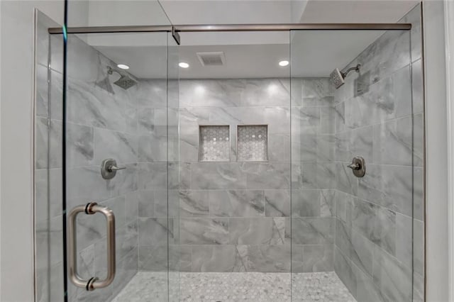 full bathroom with visible vents and a shower stall