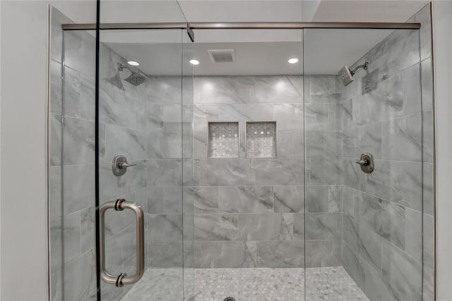 bathroom with visible vents and a shower stall