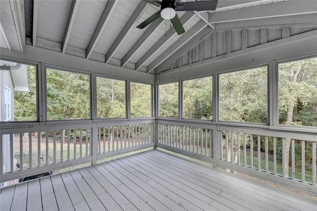 unfurnished sunroom with vaulted ceiling with beams and a ceiling fan