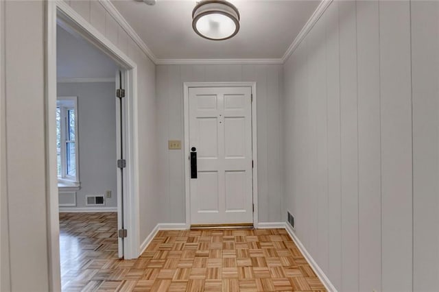 interior space featuring visible vents, ornamental molding, and baseboards