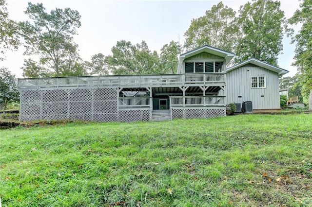 rear view of house featuring central AC unit, a lawn, and a wooden deck