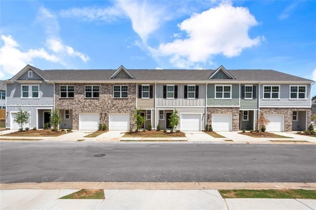 townhome / multi-family property featuring driveway and board and batten siding