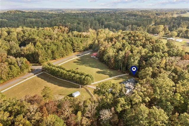 drone / aerial view with a wooded view