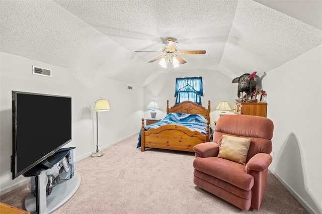 carpeted bedroom with baseboards, visible vents, lofted ceiling, ceiling fan, and a textured ceiling