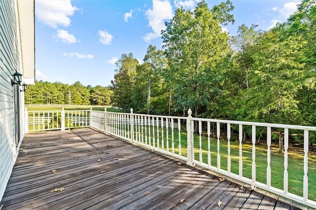 wooden terrace featuring a yard