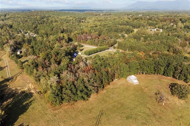 bird's eye view featuring a wooded view