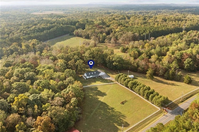 drone / aerial view featuring a rural view and a wooded view