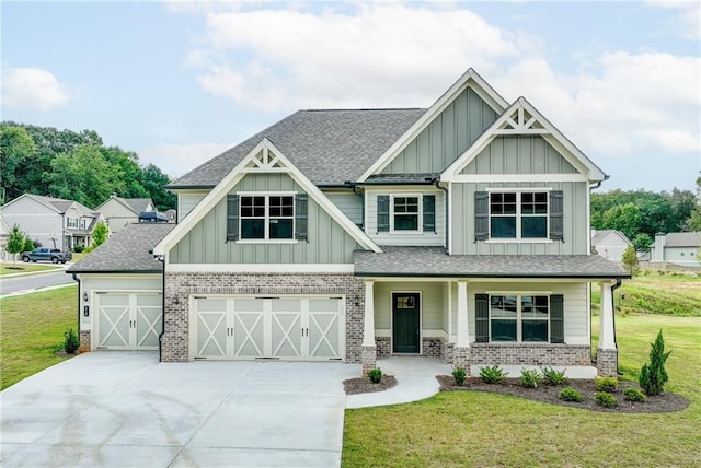 craftsman inspired home with a garage and a front lawn