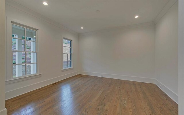 unfurnished room with crown molding and wood-type flooring