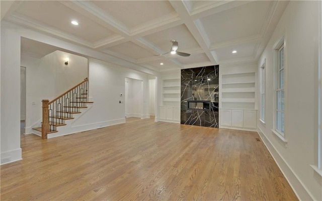 unfurnished living room with hardwood / wood-style floors, ceiling fan, and built in shelves