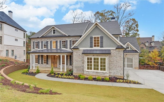 craftsman-style house featuring covered porch and a front lawn