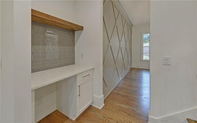 hallway with light hardwood / wood-style floors