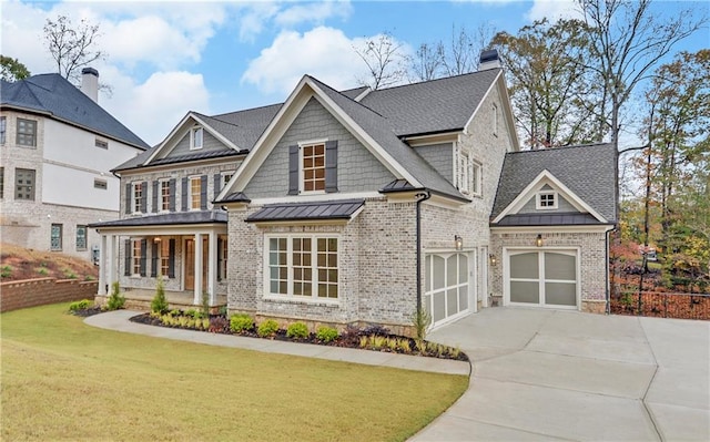 view of front of property with covered porch, a front yard, and a garage