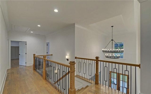 hallway featuring ornamental molding and light hardwood / wood-style flooring