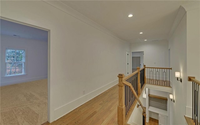 hall featuring light wood-type flooring and crown molding