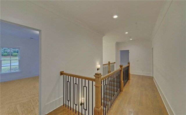 corridor featuring light hardwood / wood-style floors and ornamental molding