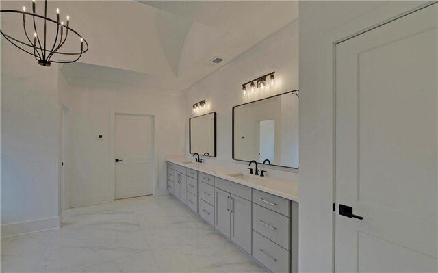 bathroom featuring vanity, vaulted ceiling, and a notable chandelier