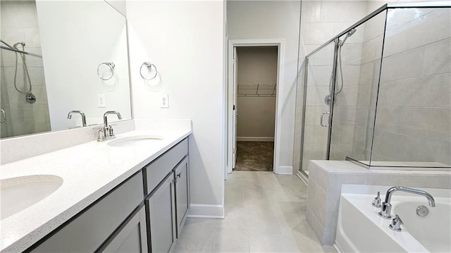 621 Pineberry Ct, Grayson, GA 30017 - bathroom with a stall shower, a spacious closet, baseboards, tile patterned flooring, and double vanity