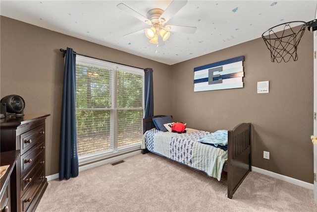 bedroom featuring light colored carpet and ceiling fan