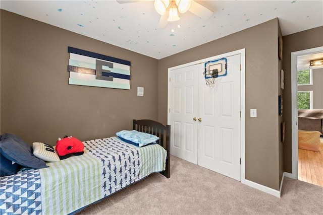 bedroom with a closet, ceiling fan, and carpet