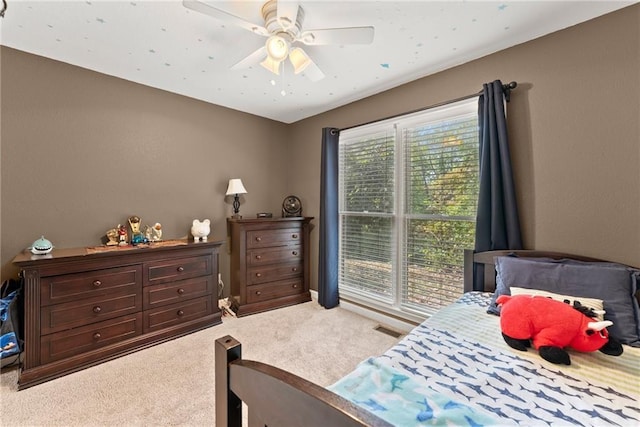 carpeted bedroom with ceiling fan