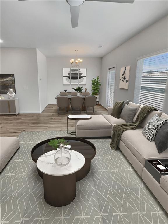 living room with hardwood / wood-style floors and a notable chandelier