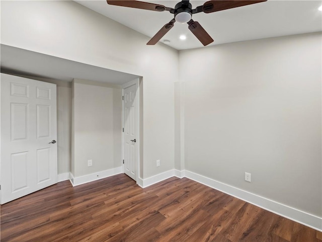 empty room with a ceiling fan, baseboards, dark wood-type flooring, and recessed lighting