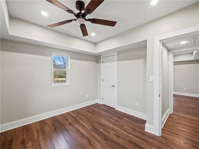 unfurnished bedroom featuring baseboards, dark wood-style flooring, and recessed lighting