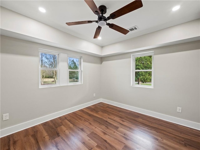 unfurnished room featuring baseboards, visible vents, wood finished floors, and recessed lighting