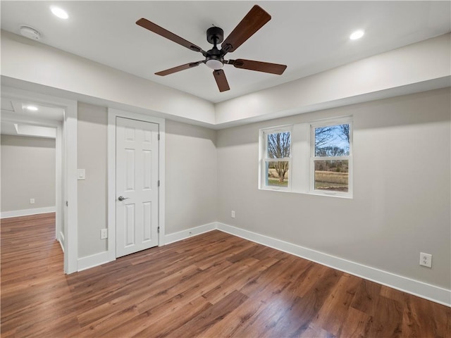 interior space featuring recessed lighting, wood finished floors, and baseboards