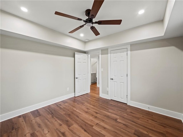 unfurnished bedroom with ceiling fan, recessed lighting, wood finished floors, and baseboards