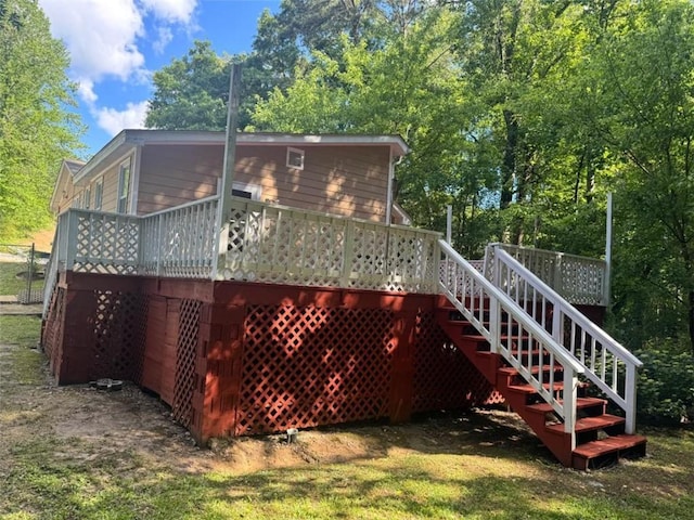 back of property featuring a wooden deck and stairs