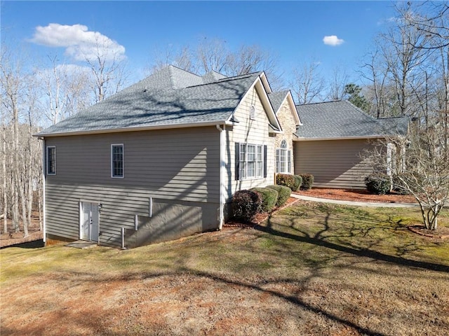 view of property exterior with a yard