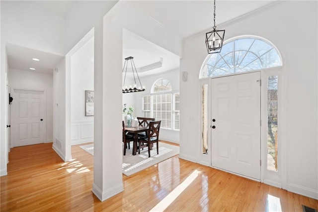 foyer featuring an inviting chandelier and light hardwood / wood-style flooring