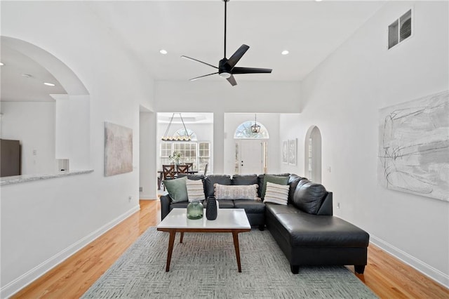 living room with hardwood / wood-style floors and ceiling fan