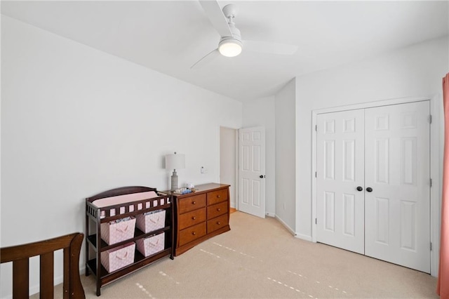 carpeted bedroom featuring a closet and ceiling fan