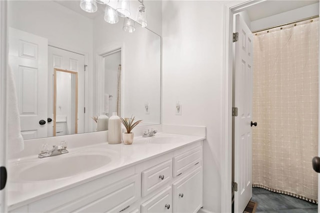 bathroom featuring walk in shower and vanity