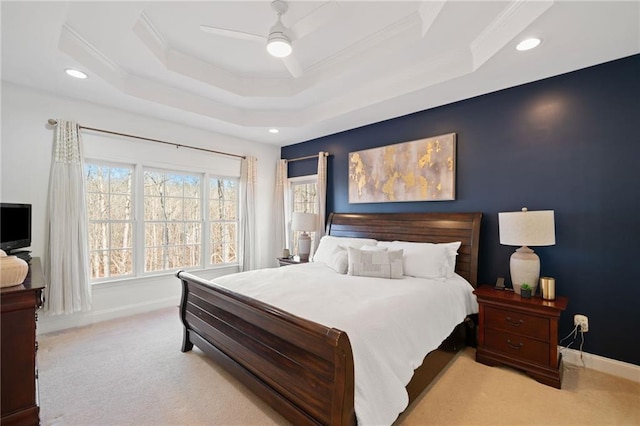 carpeted bedroom featuring crown molding, ceiling fan, and a tray ceiling