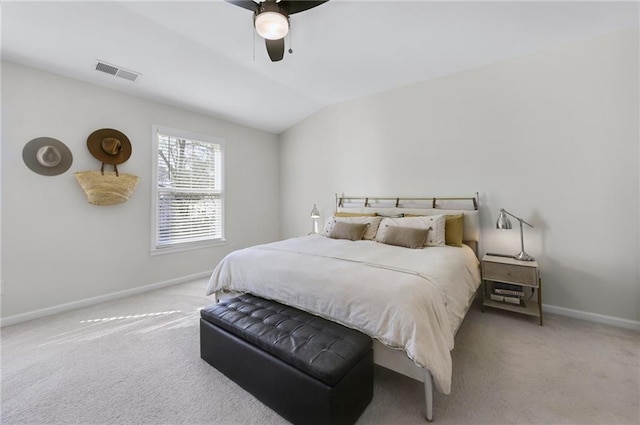 carpeted bedroom with visible vents, ceiling fan, baseboards, and vaulted ceiling